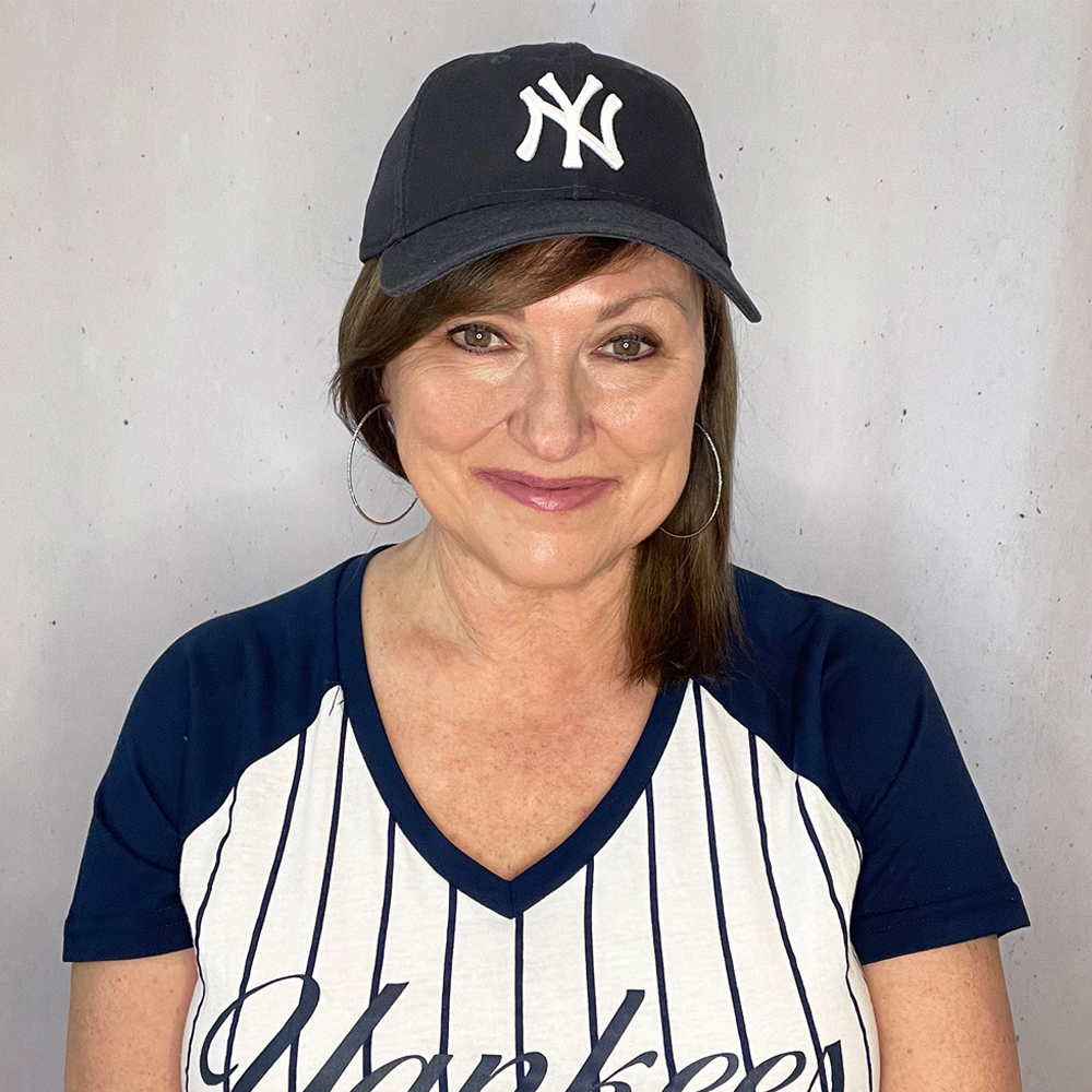 Dianne of the Harper Girls modeling a baseball cap.