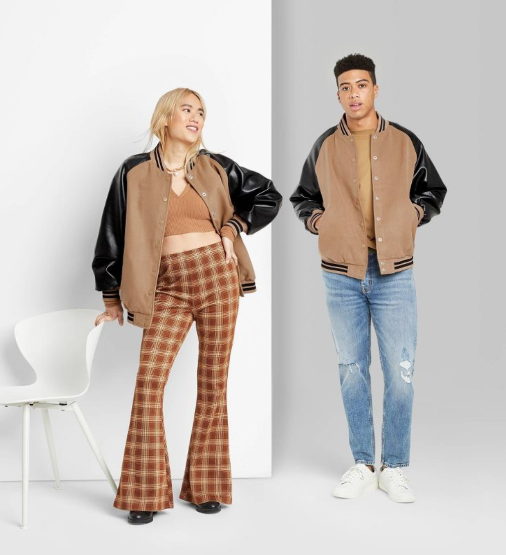 Man and woman wearing gender neutral varsity jacket.