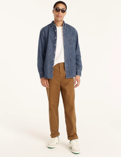 Man wearing denim shirt and khaki pants.