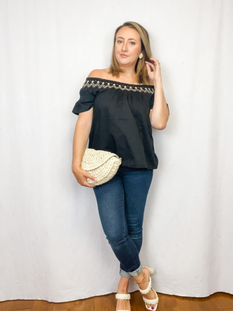 Jen of the Harper Girls wearing a black off the shoulder top