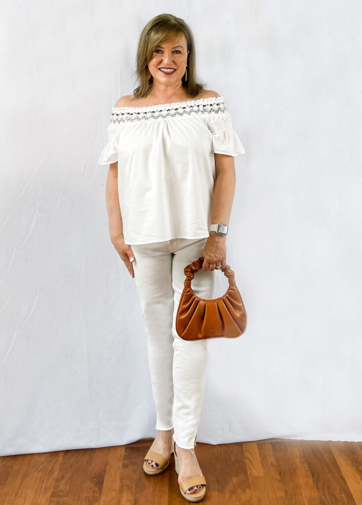 Dianne of the Harper Girls wearing a black off the shoulder top