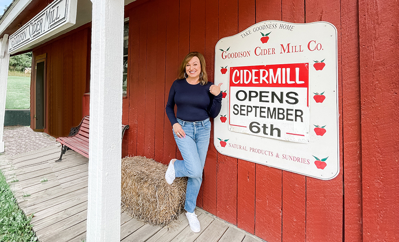 Woman at a cider mill wearing transitional basics