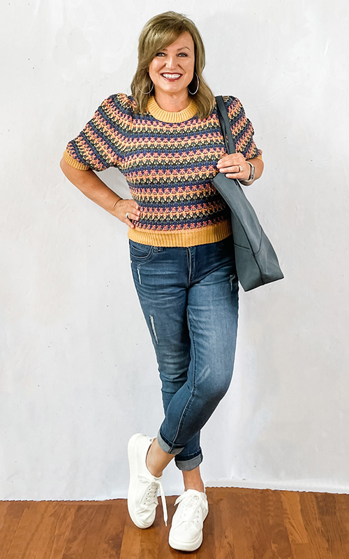 Woman wearing puff sleeve elbow sweater with sneakers.