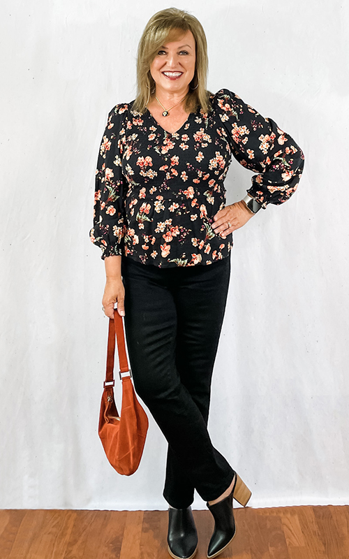 Woman wearing black block heel mule shoe