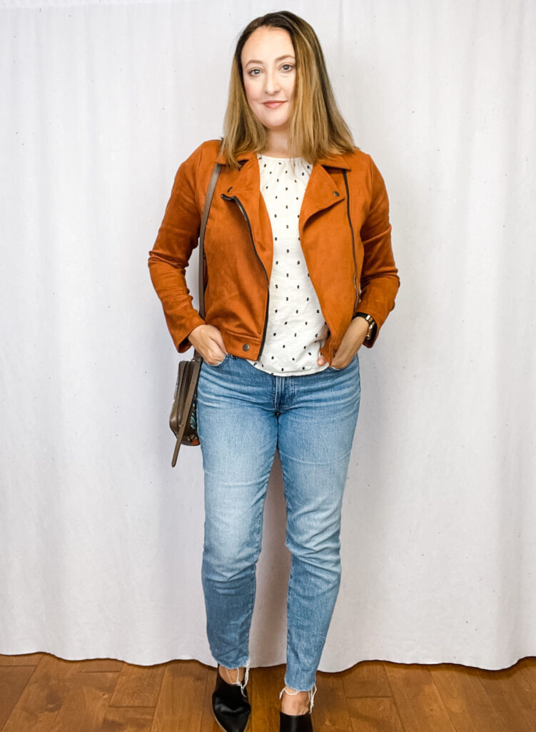 Woman wearing rust orange suede moto jacket