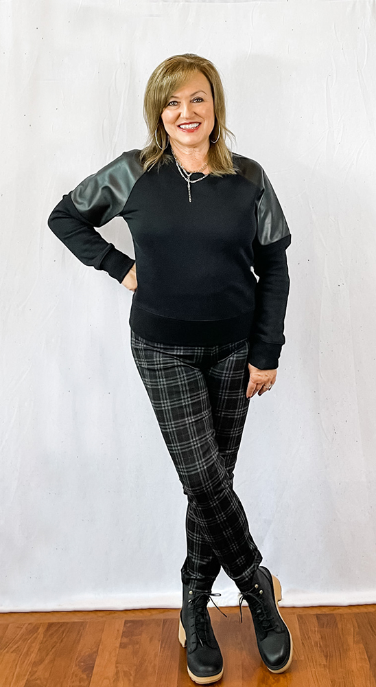Woman wearing a faux leather sweatshirt from Evereve