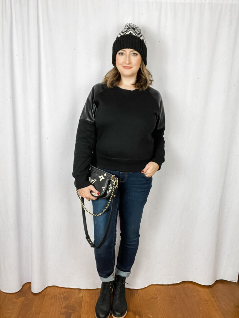 Woman wearing faux leather sweatershirt from Evereve