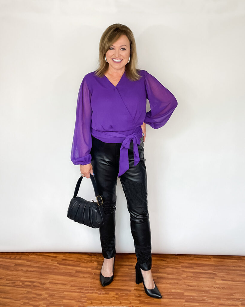 Woman wearing purple top and leather pants