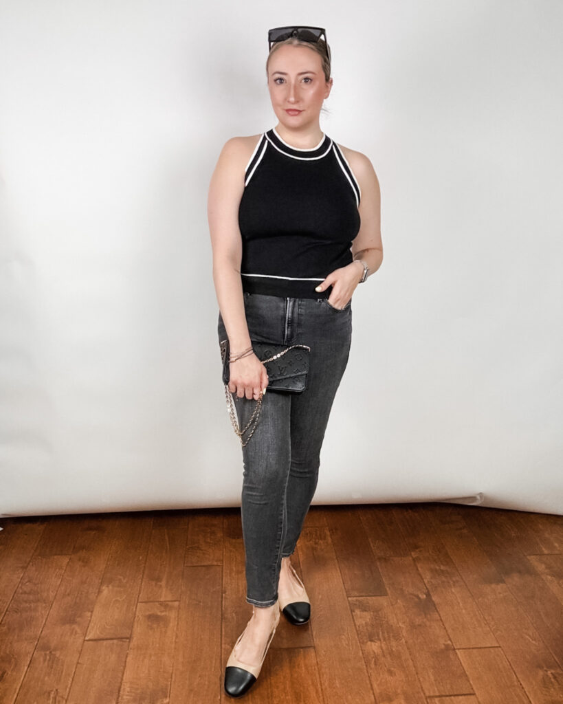 Woman in black sweater with white trim